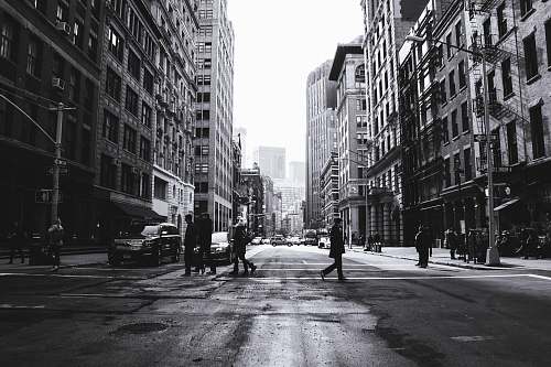 road grayscale photography of people crossing the street manhattan